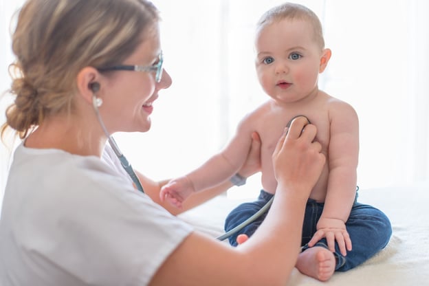 Cute baby examined by a female doctor